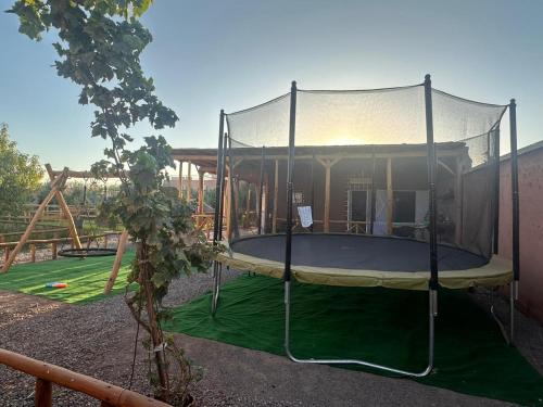 a trampoline with a canopy in a playground at Villa Dar Hamza Marrakech in Tahannout