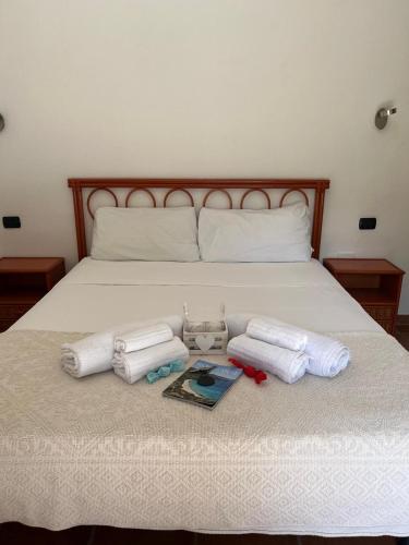 a bed with two towels and two magazines on it at Almà in Torre delle Stelle