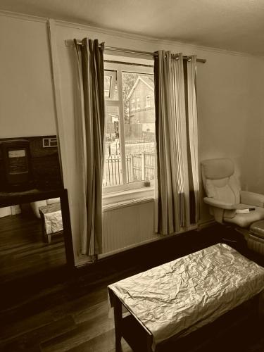 a small bedroom with a bed and a window at High Class Accommodations 20 in Bury