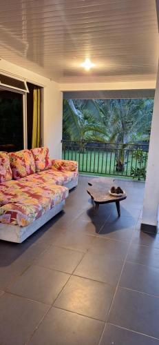 a living room with a couch and a coffee table at Prana Lodge in Faaone