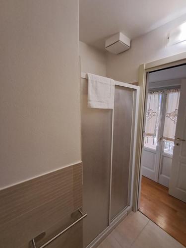 a bathroom with a shower with a towel on the wall at Royal Suite l'attico nel cuore di Varese in Varese