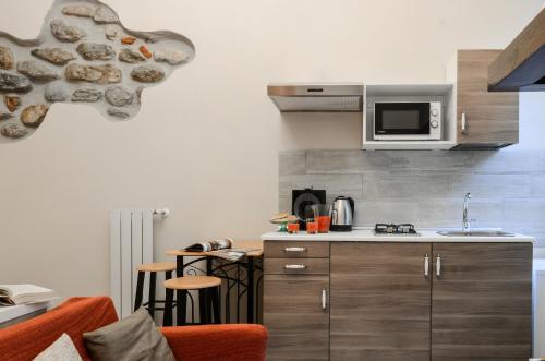 a kitchen with a microwave and a counter top at Casa Scola Loano in Loano