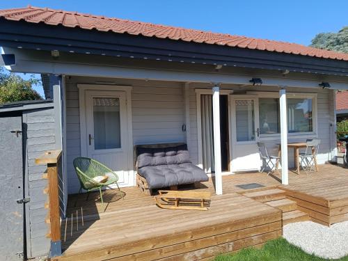 a wooden deck with a dog bed on a house at Kota coeur de bois in Bourbourg