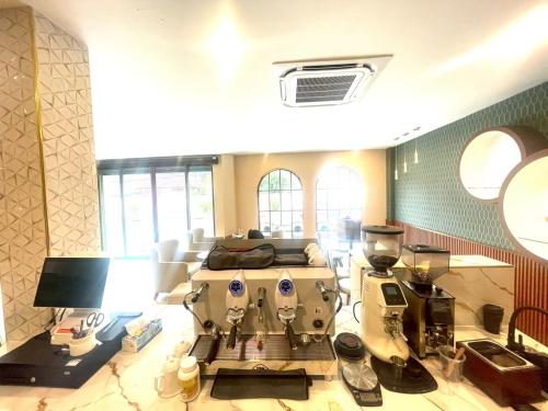 a room with a coffee machine in a room at S-room Scentral Hatyai in Hat Yai