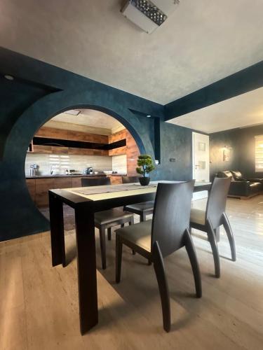 a dining room with a table and some chairs at Sweet Lux Home 1 in Smederevo