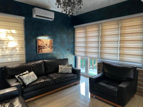 a living room with a leather couch and chairs at Sweet Lux Home 1 in Smederevo