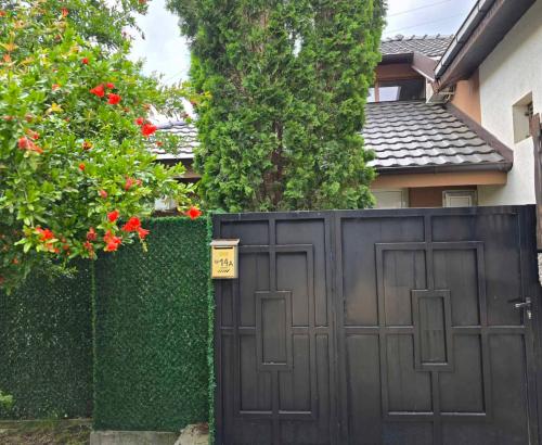 a black gate in front of a house with flowers at Sweet Lux Home 1 in Smederevo