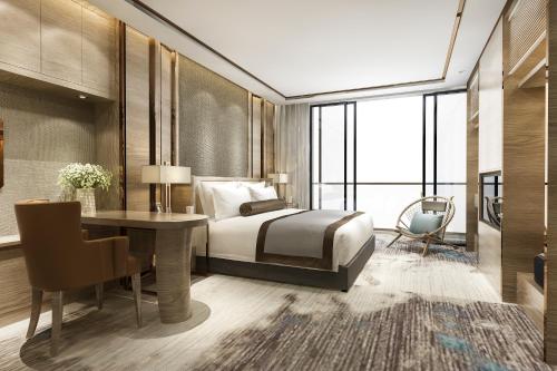 a bedroom with a bed and a desk and a chair at Hotel Paradise Park At Airport in New Delhi