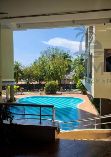 a swimming pool in the middle of a building at My Getaway Home @Marina Cove in Lumut