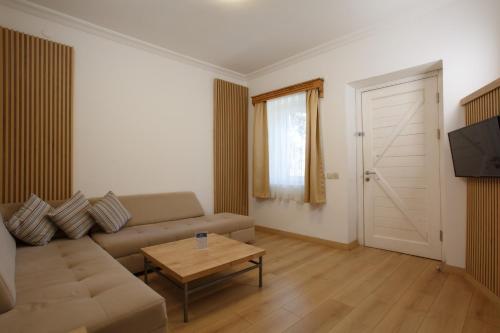 a living room with a couch and a table at Kıvanç Suite Hotel in Bodrum City