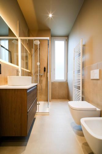 a bathroom with a sink and a toilet and a shower at Balcony Double Suite - 3 min walk to Bernina Express in Tirano