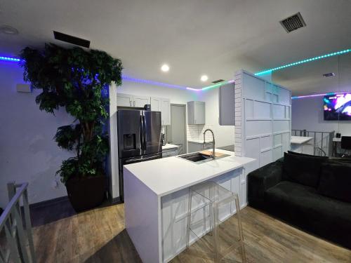 a kitchen and living room with a white counter top at Urban Treehouse in Dallas