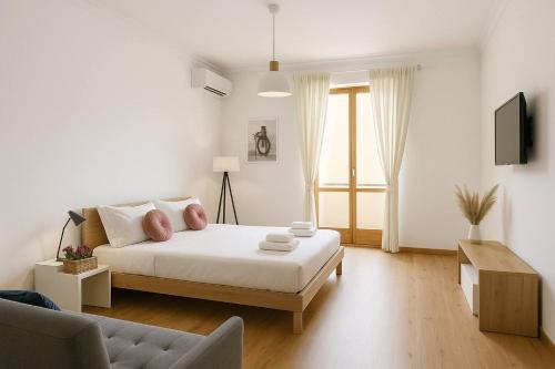 a white bedroom with a bed and a couch at Flaminio Luxury Home - City Center in Rome