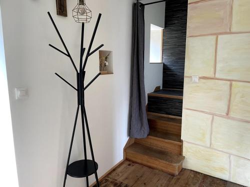a living room with a plant in the corner of a room at Appartement campagne normande in Athis