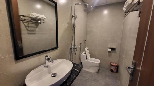 a bathroom with a sink and a toilet at Lotus Hostel Ha Giang Loop in Ha Giang