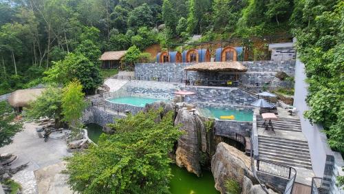 a resort with a swimming pool on a mountain at Lotus Hostel Ha Giang Loop in Ha Giang
