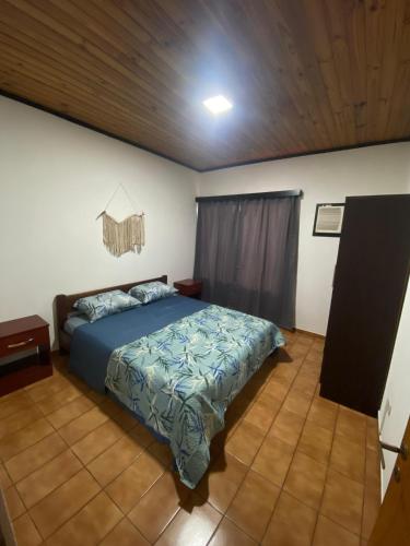 a bedroom with a bed and a wooden ceiling at Julius Apart in Eldorado