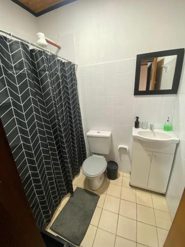 a bathroom with a toilet and a sink at Julius Apart in Eldorado