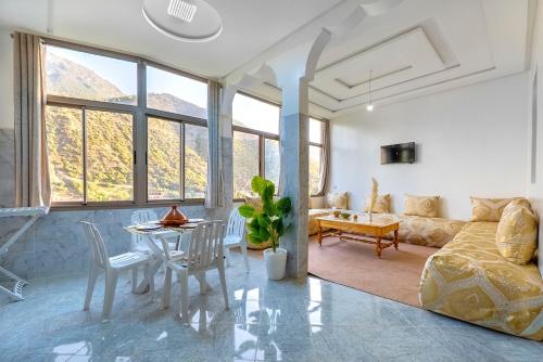 a living room with a couch and a table at Dar Ourika - Mountain Views in Ourika