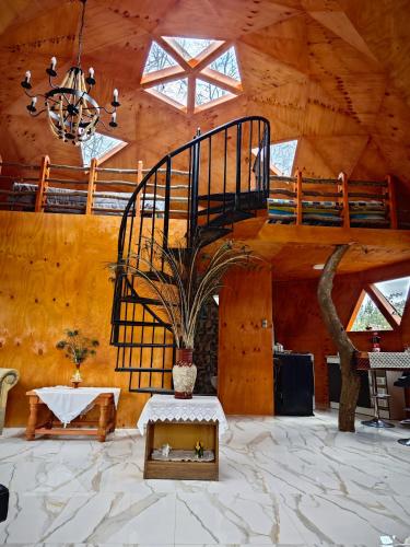 a room with a staircase and a vase with a plant at Cabañas del real in San Fabián de Alico
