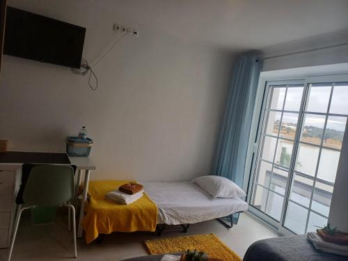 a small room with a bed and a window at Sunny Room - Sofia's Happy House - Almodôvar Ourique Room 2 in Aldeia dos Fernandes