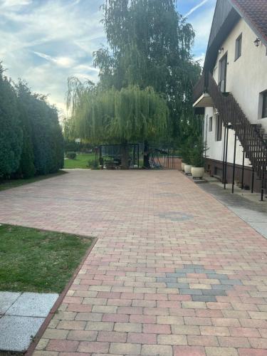 a brick driveway in front of a house at Tenisz vendégház in Ordacsehi