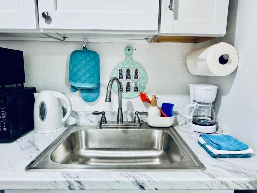 a kitchen counter with a sink and a mixer at 1 Bedroom Mini Apartment 10 Minutes to SeaTac Airport 1 Minute Walk to Bus Station in Seattle
