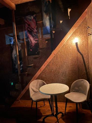 two chairs and a table and a lamp in a room at Zmajevo Gnezdo II Water House in Beograd