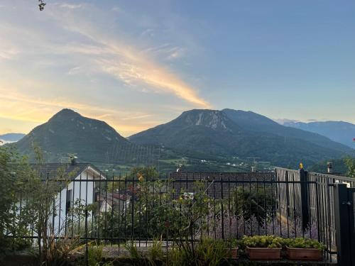 a view of mountains with a fence and mountains at Il fiore del Calisio in Trento