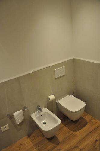 a bathroom with a toilet and a sink at Il fiore del Calisio in Trento