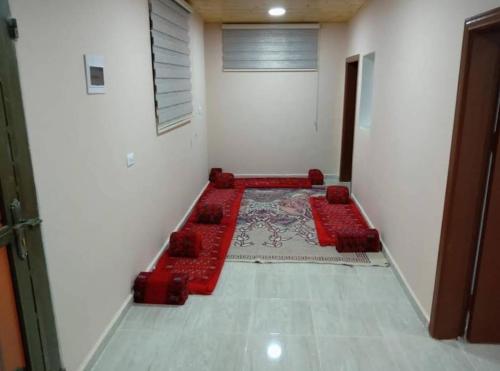 a room with red seats in the corner of a room at Idris home in Wadi Musa