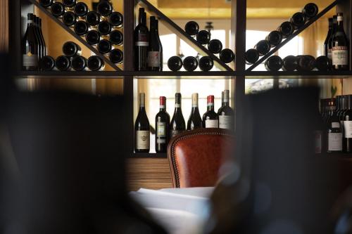a room filled with lots of bottles of wine at T'AMI Hotel Resort Spa in Selvino