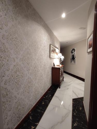 a hallway with a wall covered in wallpaper at Il Sogno di Gio de la Laguna in La Laguna