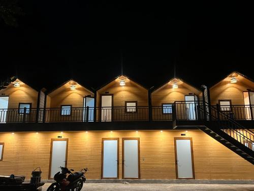 a building with a motorcycle parked in front of it at Lotus Hostel Ha Giang Loop in Ha Giang