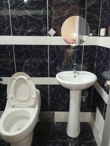 a bathroom with a toilet and a sink at Casa del Virrey Hospedaje in Jauja