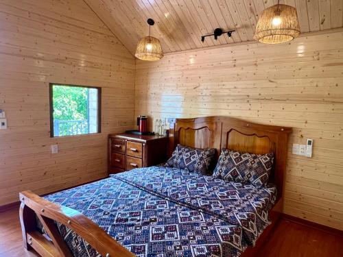a bedroom with a bed in a wooden cabin at Lotus Hostel Ha Giang Loop in Ha Giang