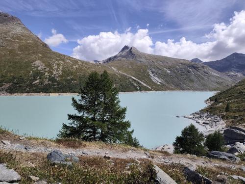 a blue lake in the middle of a mountain at Lonys Wanderlust Nahe Zermatt in Sankt Niklaus