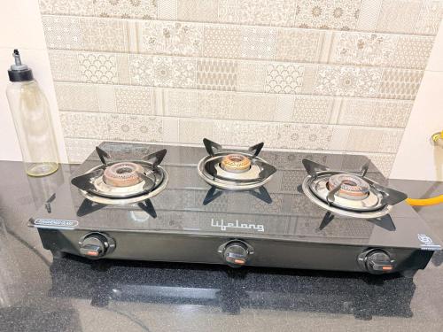 a stove top with two plates of food on top at New Stay Offer - Luxury 3BHK with Jacuzzi in Balcony in Jaipur