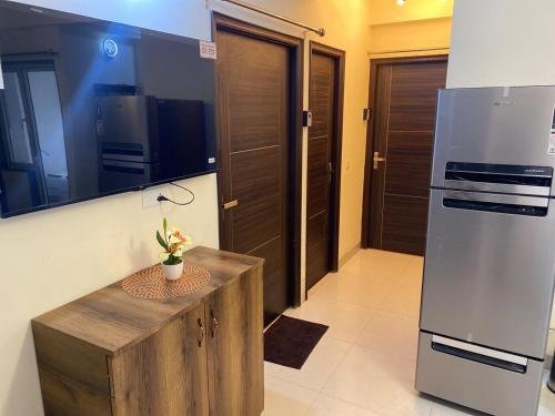 a kitchen with a wooden table and a refrigerator at New Stay Offer - Luxury 3BHK with Jacuzzi in Balcony in Jaipur