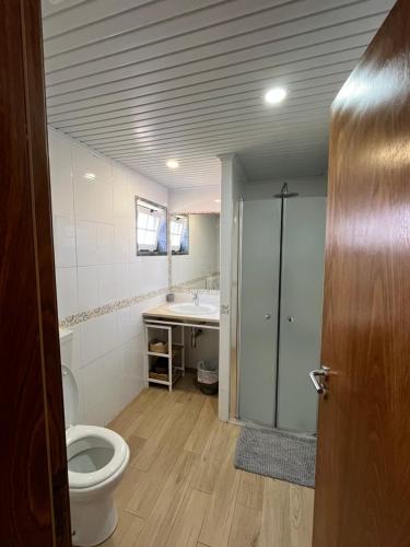 a bathroom with a toilet and a sink at Casa Isa By Natasha Gomes in Almograve