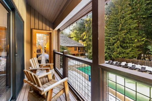 two chairs on a balcony with a view of a pool at LOGE Alta Crystal in Enumclaw