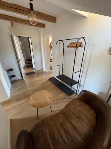 a living room with a couch and a chair at Comfy, Spacious and Central Duplex Apartment in Zweisimmen