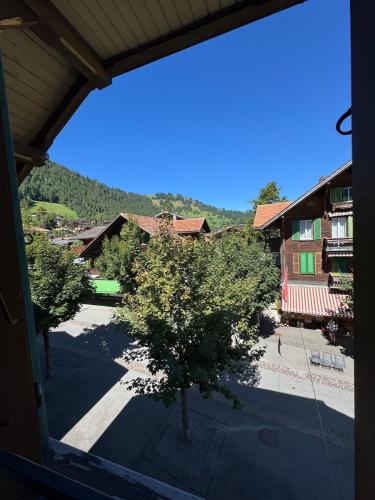 a view from a window of a town with trees at Comfy, Spacious and Central Duplex Apartment in Zweisimmen