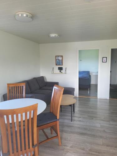 a living room with a couch and a table and chairs at Vonarland in Stokkseyri
