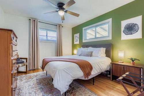 a bedroom with a bed and a ceiling fan at Colorful Colorado Home - 20 min to Denver in Northglenn