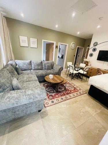 a living room with a couch and a table at Burton Urban Apartment A in Burton upon Trent