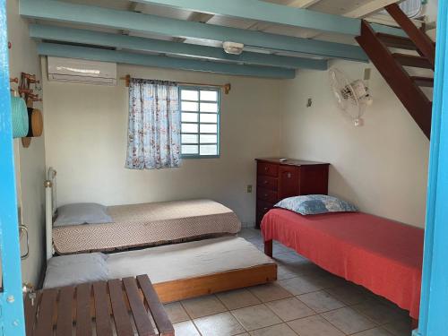 a bedroom with two beds and a window at Casa Arakyssawa in Salvaterra