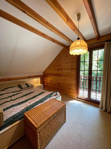 a bedroom with a bed and a large window at De Goudvink 