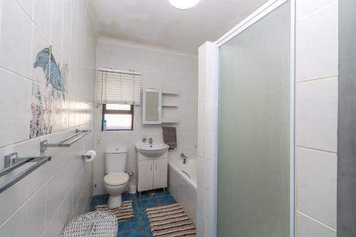 a white bathroom with a toilet and a sink at Ramsgate Mews 2 in Ramsgate