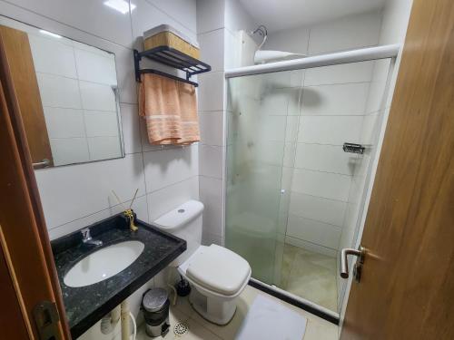 a bathroom with a sink and a toilet and a shower at Porto de Galinhas Pé na Areia Belize in Porto De Galinhas
